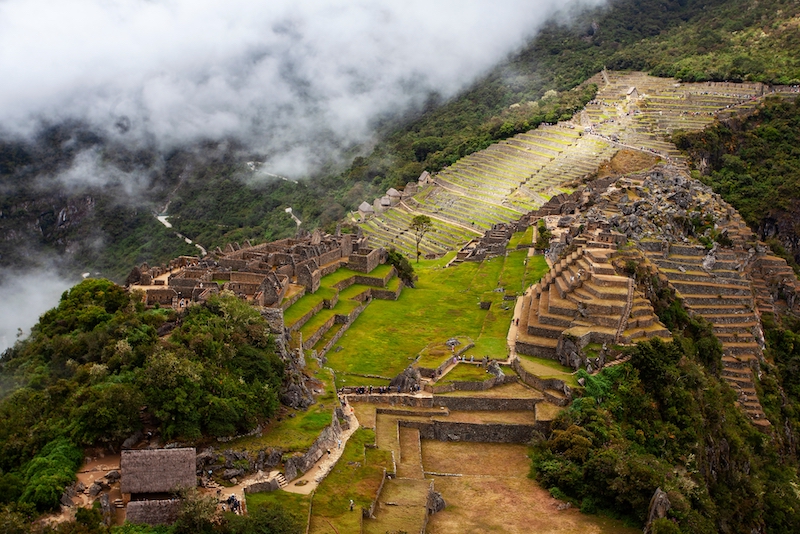 A view of Machu Picchu on a cloudy day from the nearby peak of Huchuy Picchu.